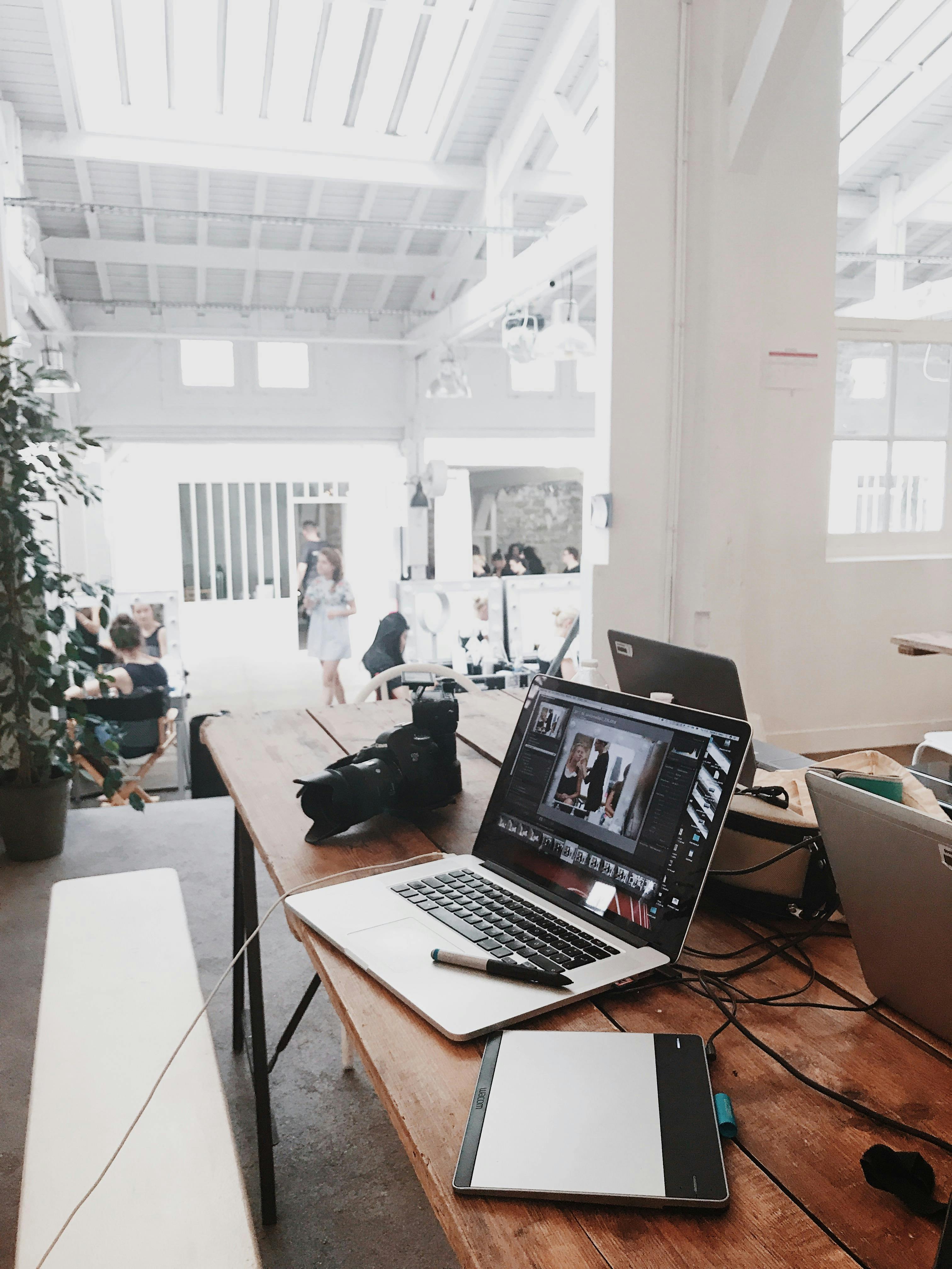 Person working on laptop in collaborative workspace